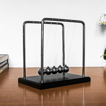 The Source Newtons Cradle